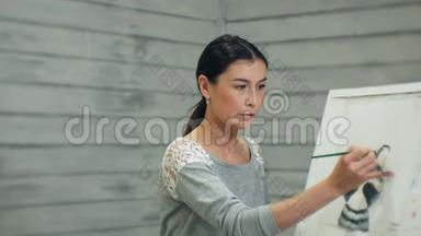 一位年轻英俊的老师在黑板上画画，在美术课上教书